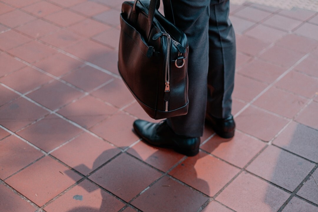 man in suit selecting leather bag
