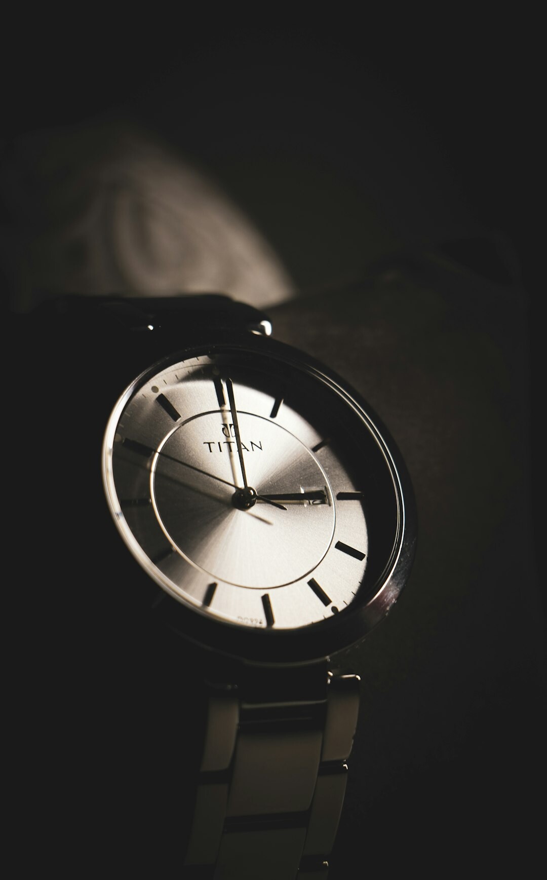 Minimalist leather strap wristwatch on a linen surface