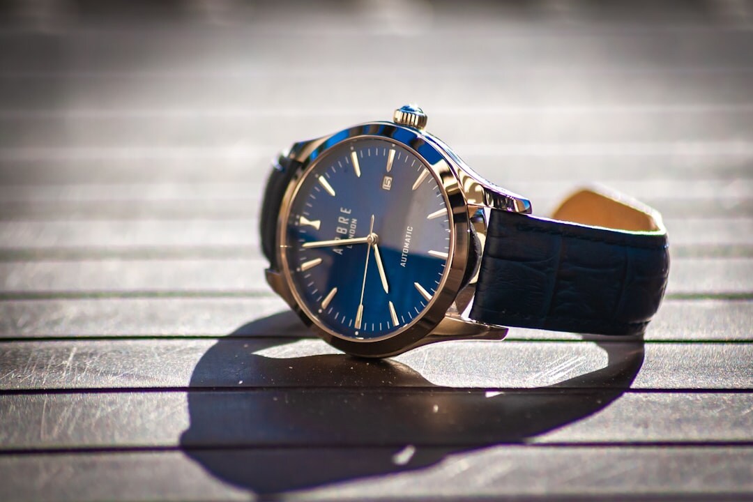 Elegant gold dress watch resting on dark leather